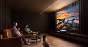 If you have to entertain yourself at home, you may as well do it right family watching big screen tv