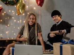 Tips for Gifting Electronics couple wraping christmas gifts