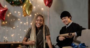 Tips for Gifting Electronics couple wraping christmas gifts