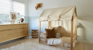 Rugs for a Baby Nursery, here is why This cozy and inviting nursery features a soft, shaggy rug that perfectly complements the warm, natural tones of the wooden furniture.